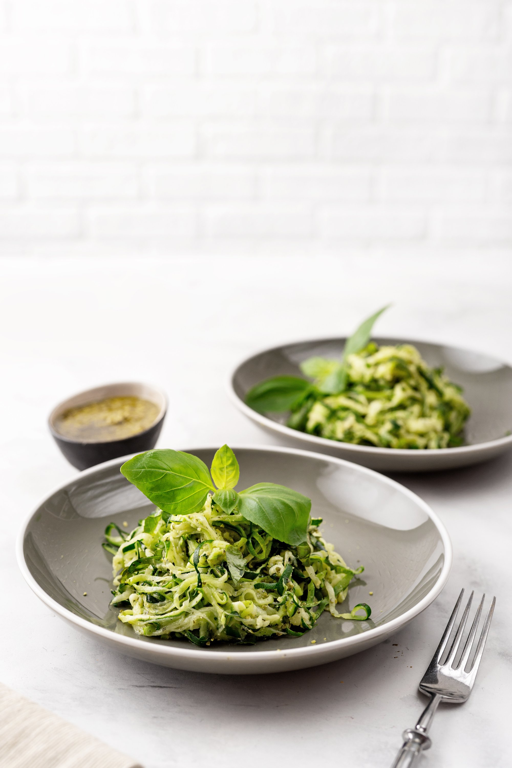 Zucchini vegan pasta on white background. Vegetarian healthy food